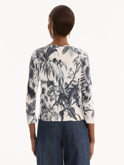 The model is wearing the Chiné Palm Leaves Cardigan in Navy and White. Featuring a crew neckline, quarter-length sleeves, banded trim, and tie front closure. Back View.