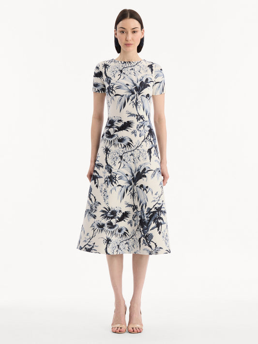 The model is wearing the Chiné Palm Leaves Knit Dress in Navy and Ivory. Featuring a classic silhouette with short sleeves and an A-line midi skirt. Front View.