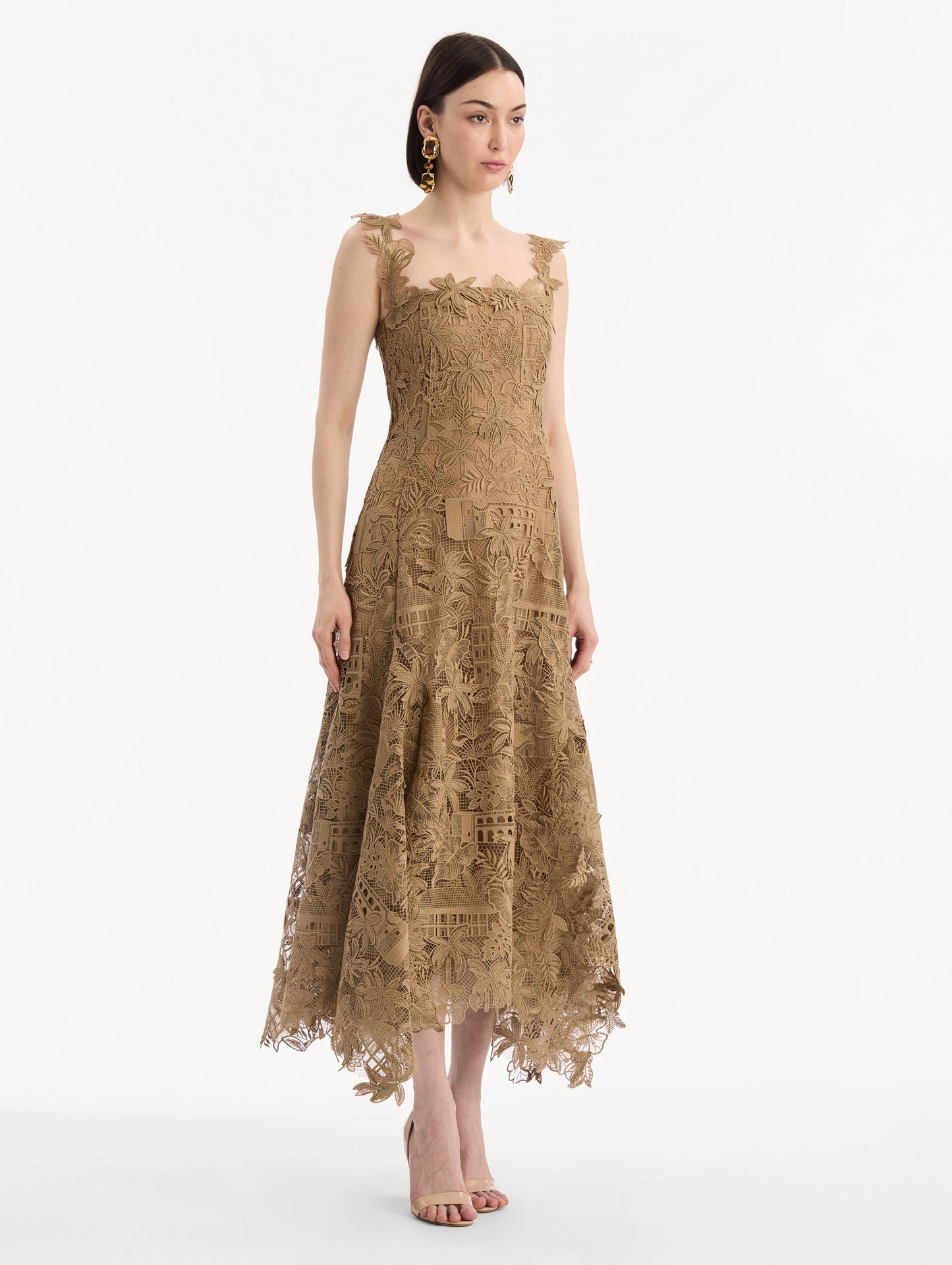 The model is wearing the Dominican Landscape Guipure Dress. Featuring a square neckline, tank straps, and lace guipure fabrication. Side View.