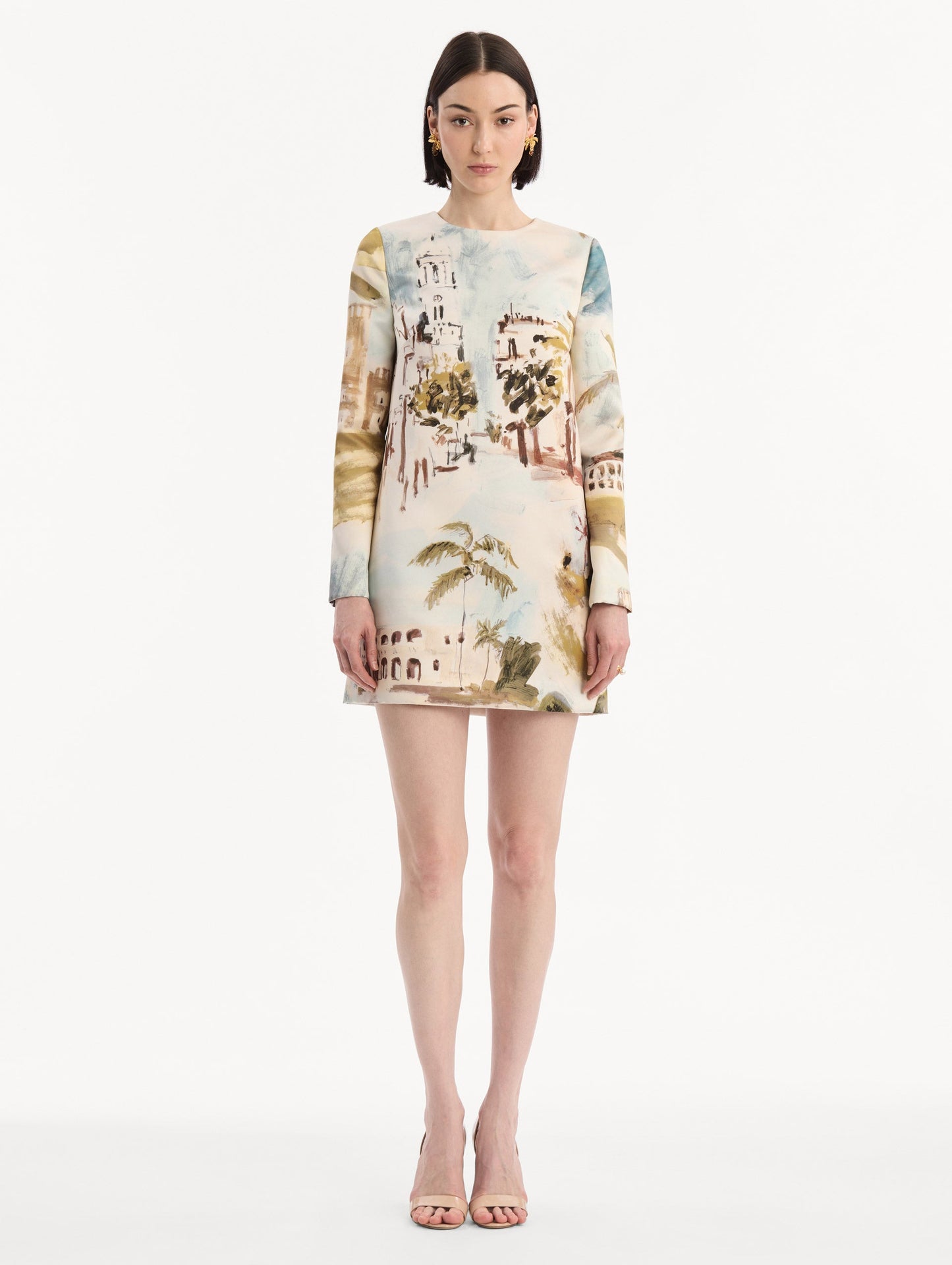 The model is wearing the Dominican Landscape Shift Dress. Featuring long sleeves and a mini length. Front View.