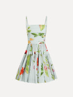 The Chiné Dominican Mixed-Floral Cotton Poplin Tiered Dress in light blue printed with a vibrant array of Dominican florals. Featuring a ruched bodice, tank straps, and gathered mini skirt. Front View.
