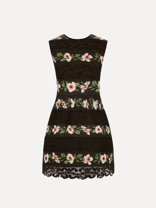 The Chiné Hibiscus Striped Faille Dress in Black. Featuring woven hibiscus motifs alternating with panels of faille and guipure lace, creating a striped pattern. Mini length. Front View.