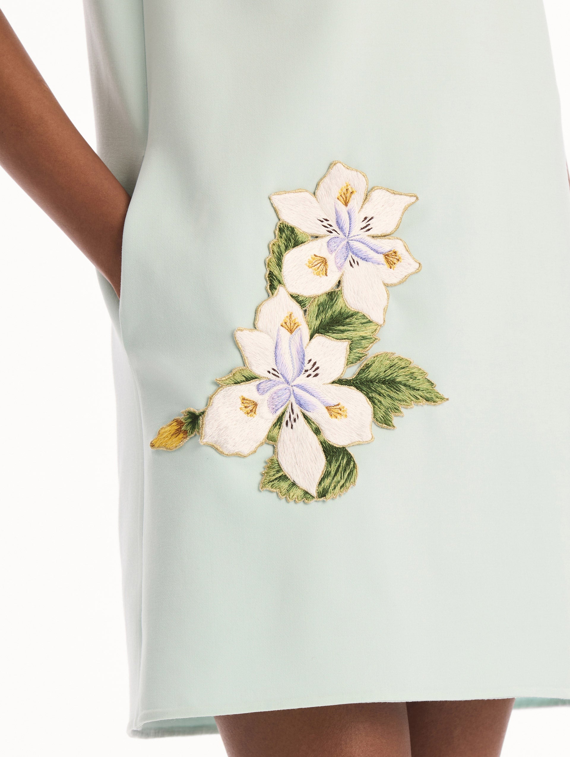The model is wearing the Dominican Mixed-Floral Threadwork Shift Dress in Saltwater. Featuring open collar neckline and mini length. Detail View.