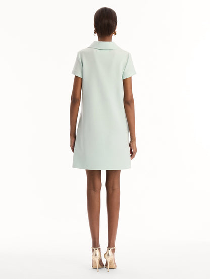 The model is wearing the Dominican Mixed-Floral Threadwork Shift Dress in Saltwater. Featuring open collar neckline and mini length. Back View.