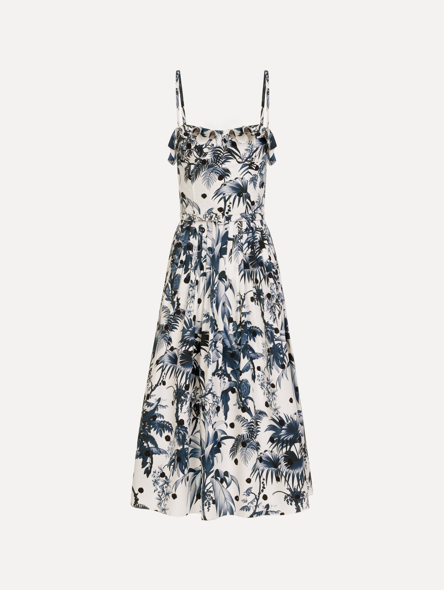 The Dotted Palm Leaves Cotton Poplin Sleeveless Dress in Navy Blue and White. Featuring a palm leaves print, ruffled top, delicate straps, belt at waist, softly structured bodice, and gathered skirt. Front View.