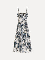 The Dotted Palm Leaves Cotton Poplin Sleeveless Dress in Navy Blue and White. Featuring a palm leaves print, ruffled top, delicate straps, belt at waist, softly structured bodice, and gathered skirt. Front View.