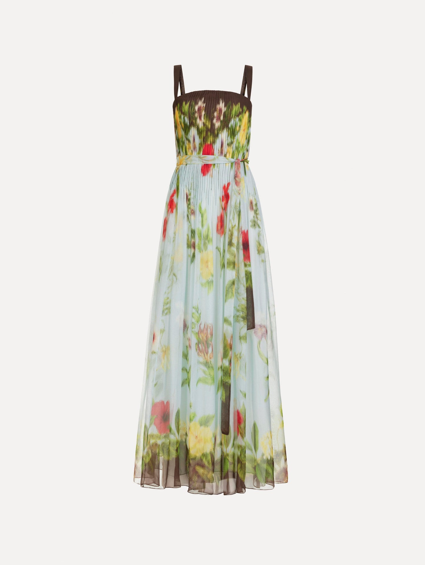 The Dominican Mixed-Floral Silk Chiffon Gown in light blue printed with an array of Dominican florals and brown at the trims. Featuring a pleated bodice, tank straps, tie at waist, and long, flowing skirt. Front View.