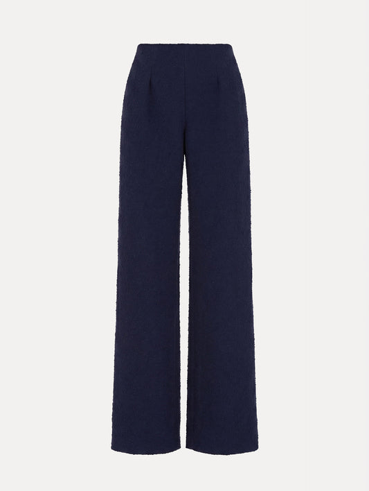 The model is wearing the slub wool tweed wide-leg pant in the color navy.