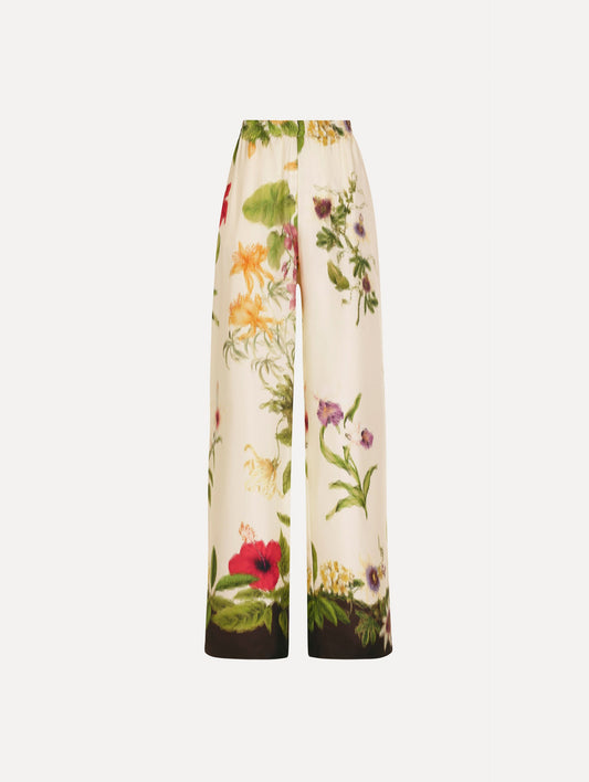 The Dominican Mixed-Floral Wide Leg Pant in ivory printed with an array of Dominican florals. Featuring wide legs and an elastic waistband. Front View.