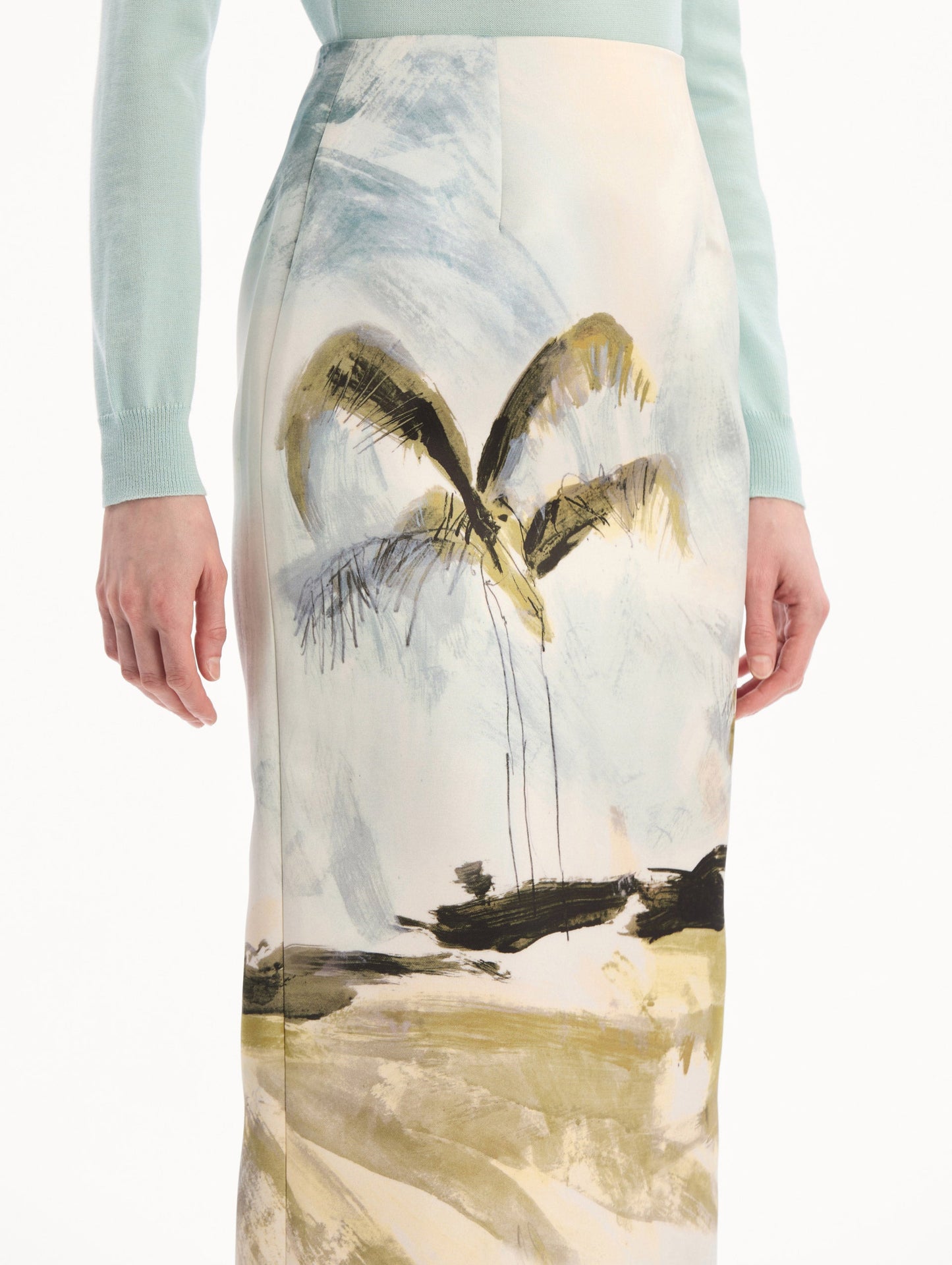 The model is wearing the Dominican Landscape Pencil Skirt printed in the Dominican landscape. Featuring a structured, column silhouette and midi length. Detail View.