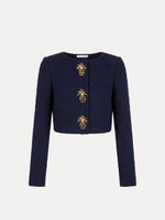 The model is wearing the slub wool tweed jacket with signature pineapple button detailing.