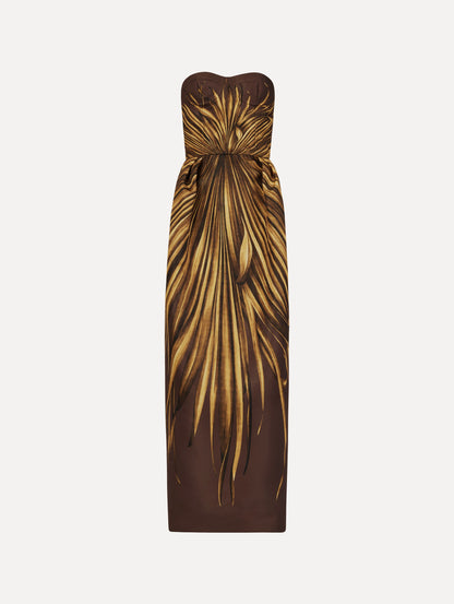 The Palm Leaves Faille Gown in brown printed with gold palm leaves. Featuring a strapless neckline, sculpted bodice, and long skirt. Front View.