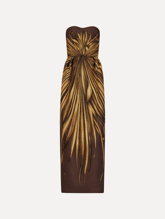 The Palm Leaves Faille Gown in brown printed with gold palm leaves. Featuring a strapless neckline, sculpted bodice, and long skirt. Front View.