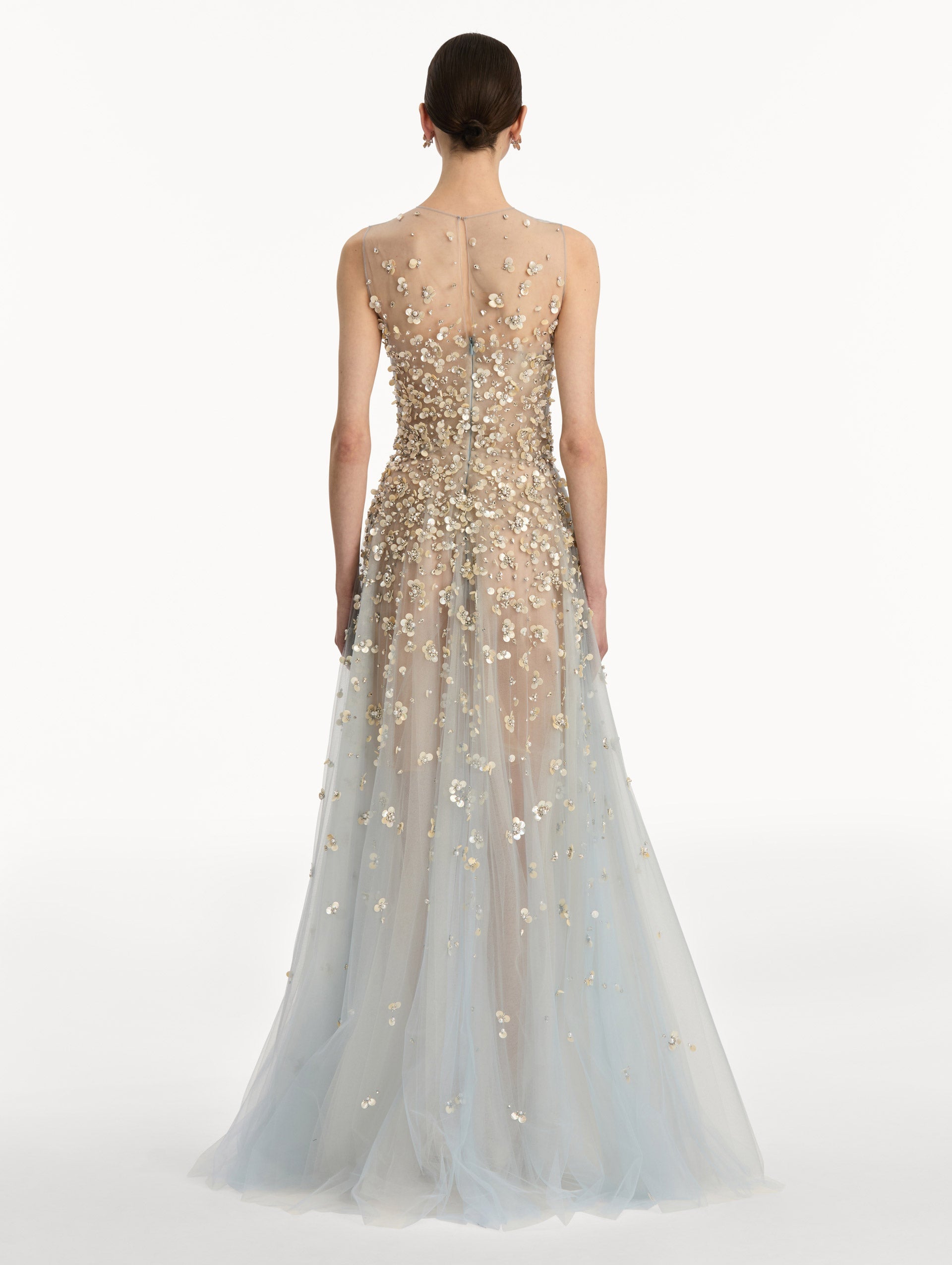 Tan and pale blue Embroidered Illusion Gown with flowing embellished skirt and scattered floral appliques. Back View.