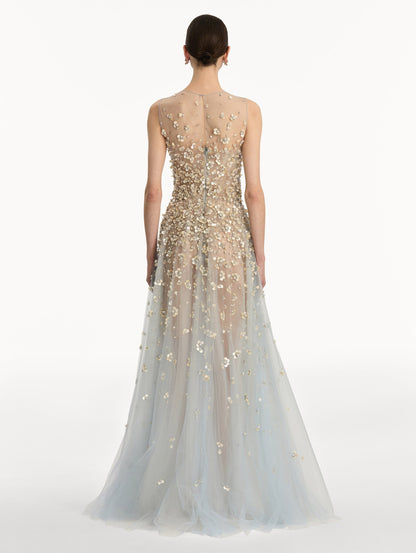 Tan and pale blue Embroidered Illusion Gown with flowing embellished skirt and scattered floral appliques. Back View.