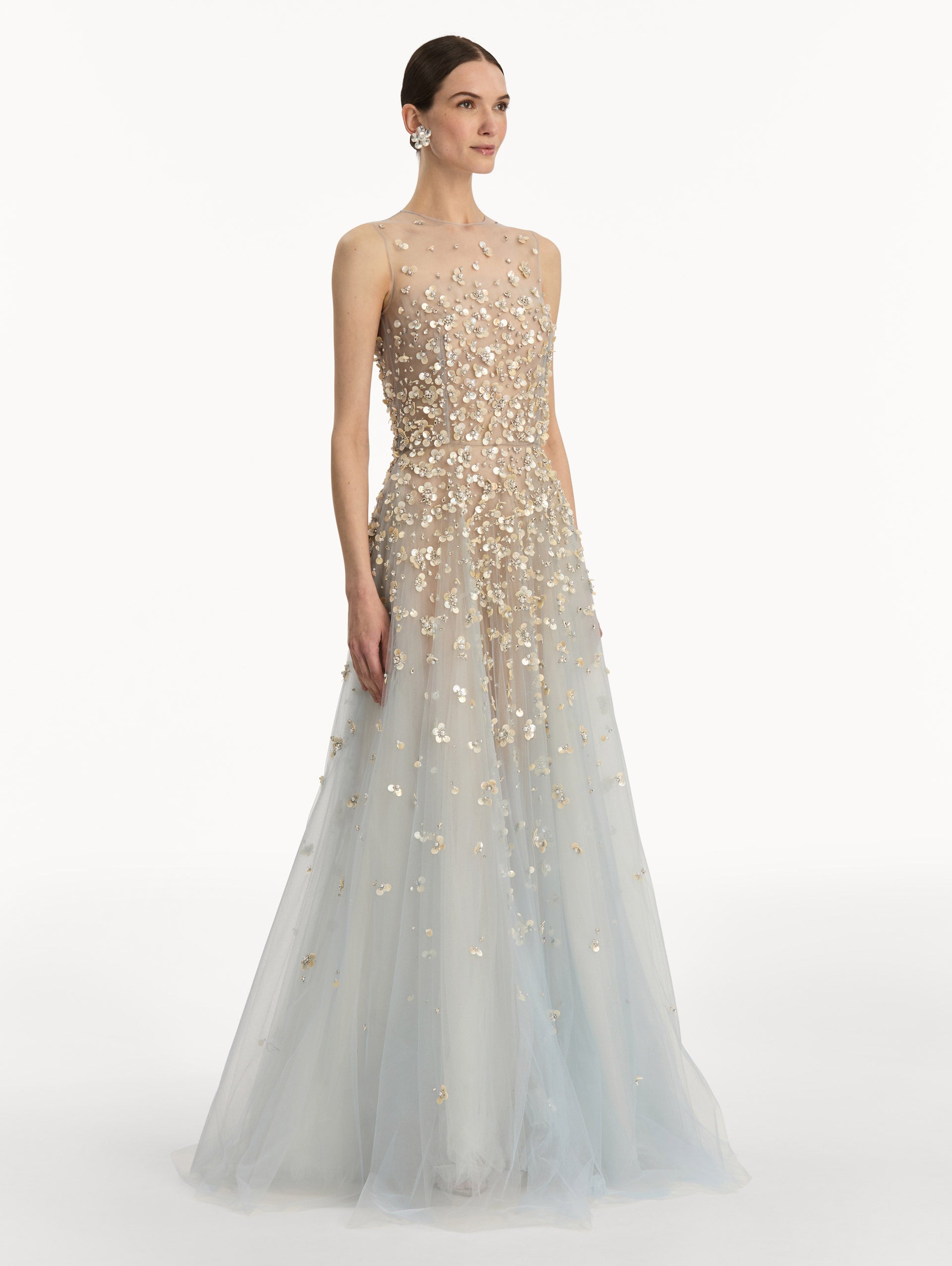 Tan and pale blue Embroidered Illusion Gown with flowing embellished skirt and scattered floral appliques. Side View.