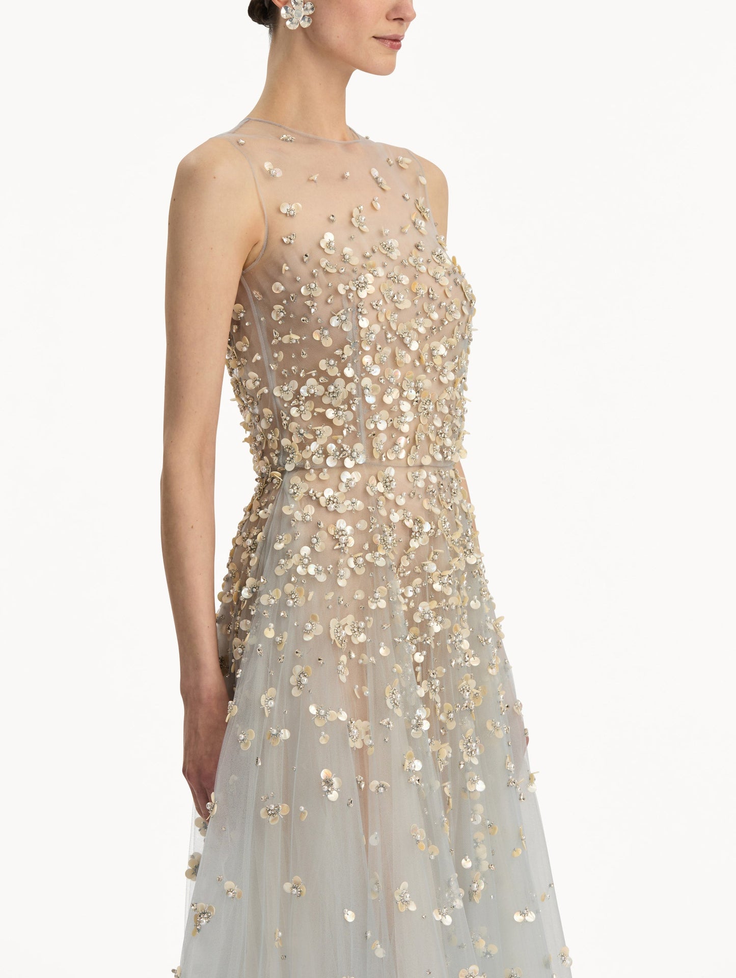 Tan and pale blue Embroidered Illusion Gown with flowing embellished skirt and scattered floral appliques. Zoom View.