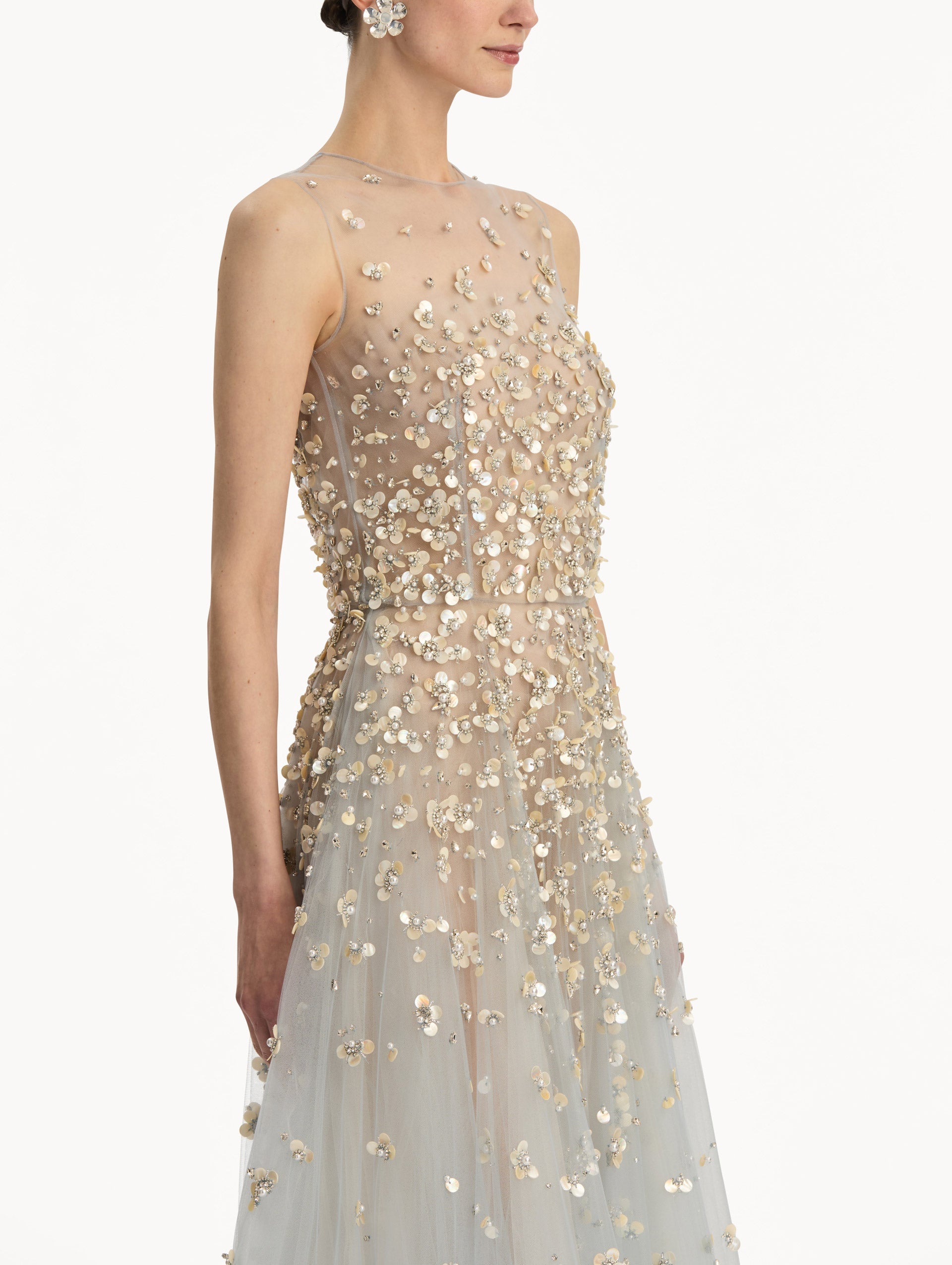 Tan and pale blue Embroidered Illusion Gown with flowing embellished skirt and scattered floral appliques. Zoom View.