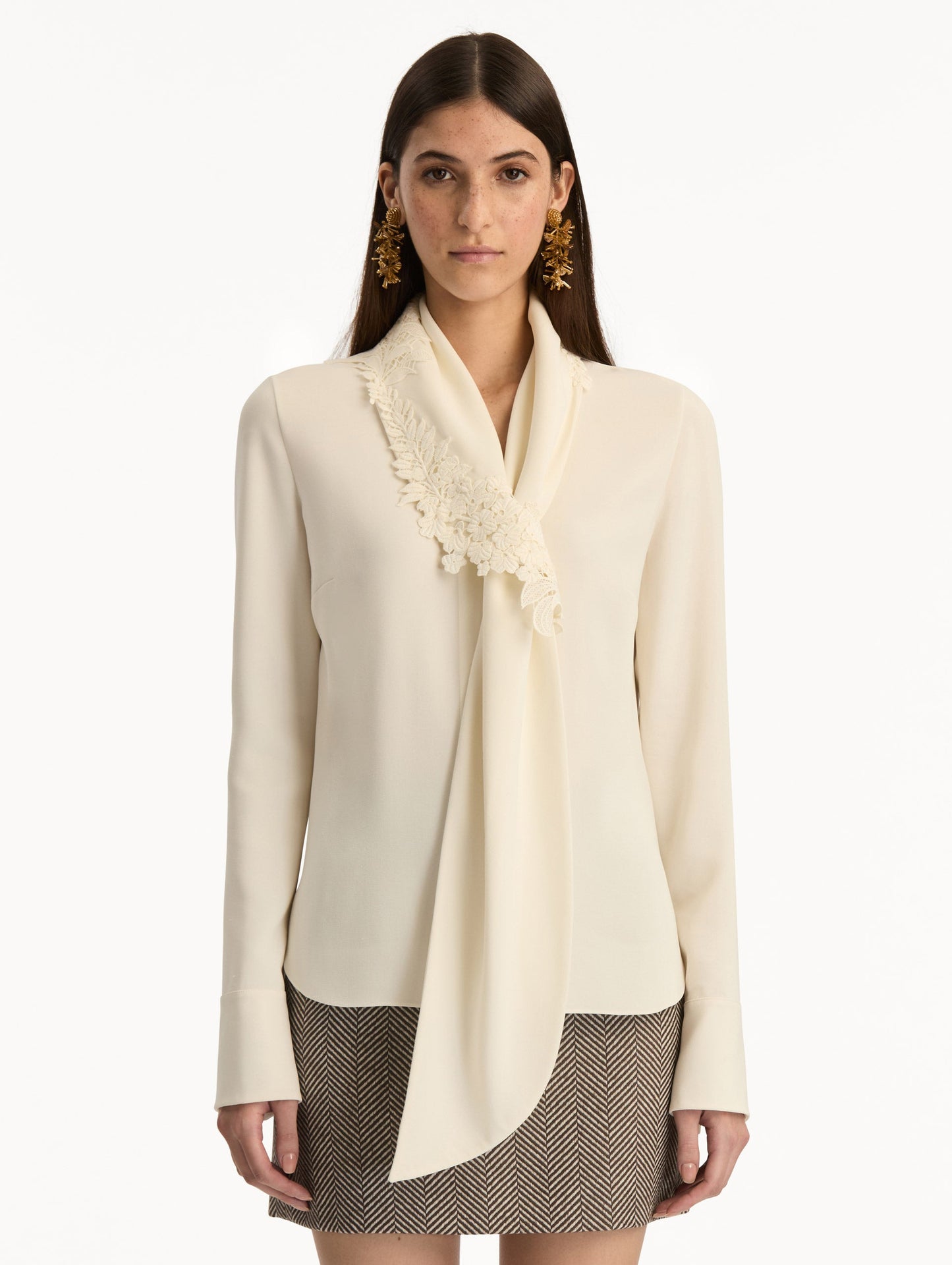 Ivory Foxglove Tie-Neck Georgette Blouse featuring a floral applique and long sleeves. Front View.