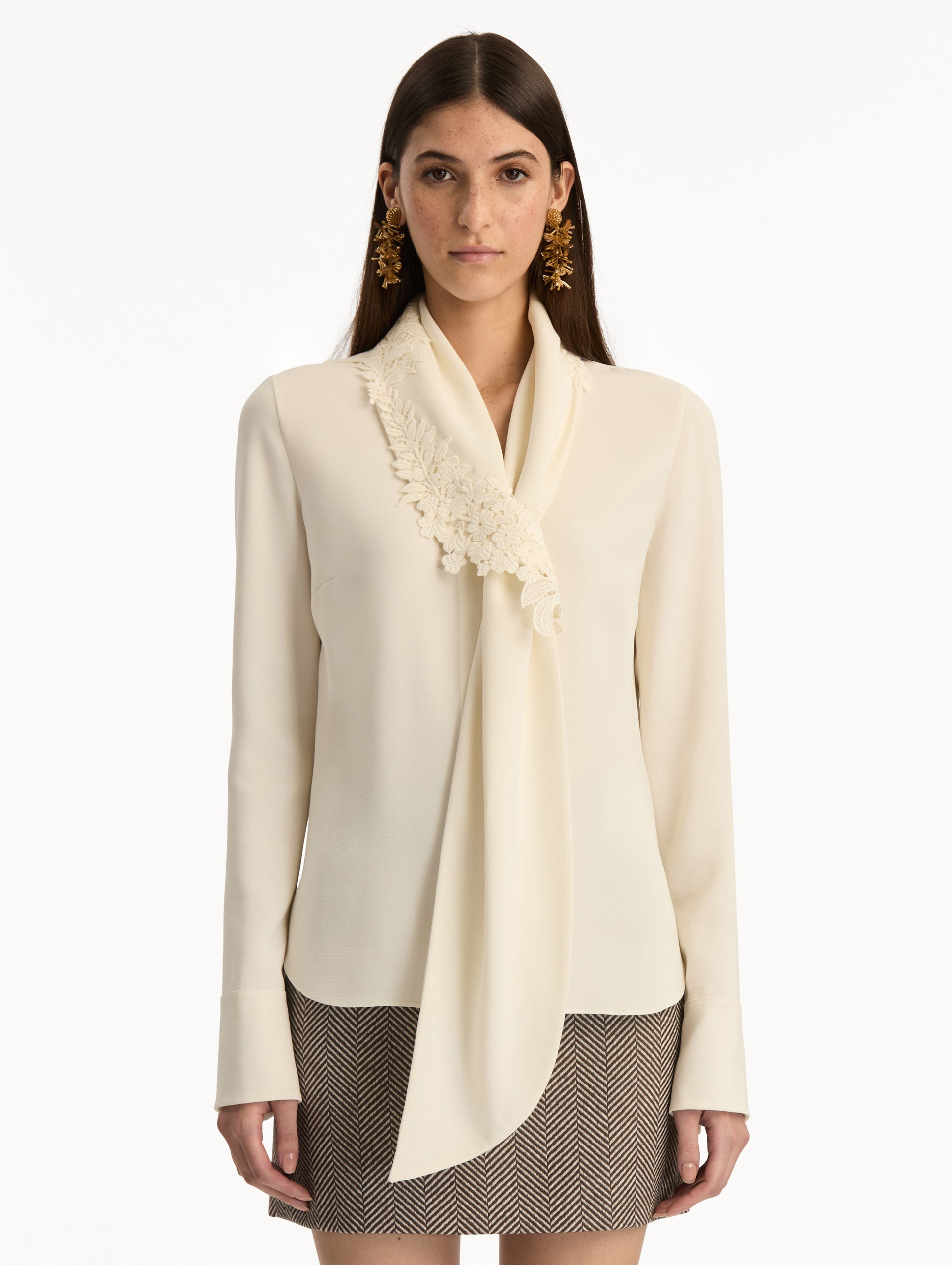 Ivory Foxglove Tie-Neck Georgette Blouse featuring a floral applique and long sleeves. Front View.