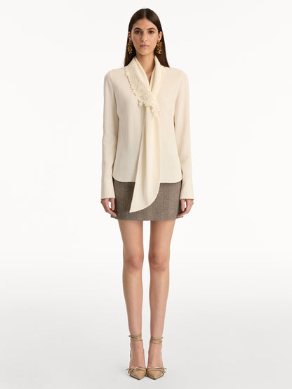 Ivory Foxglove Tie-Neck Georgette Blouse featuring a floral applique and long sleeves. Front View.