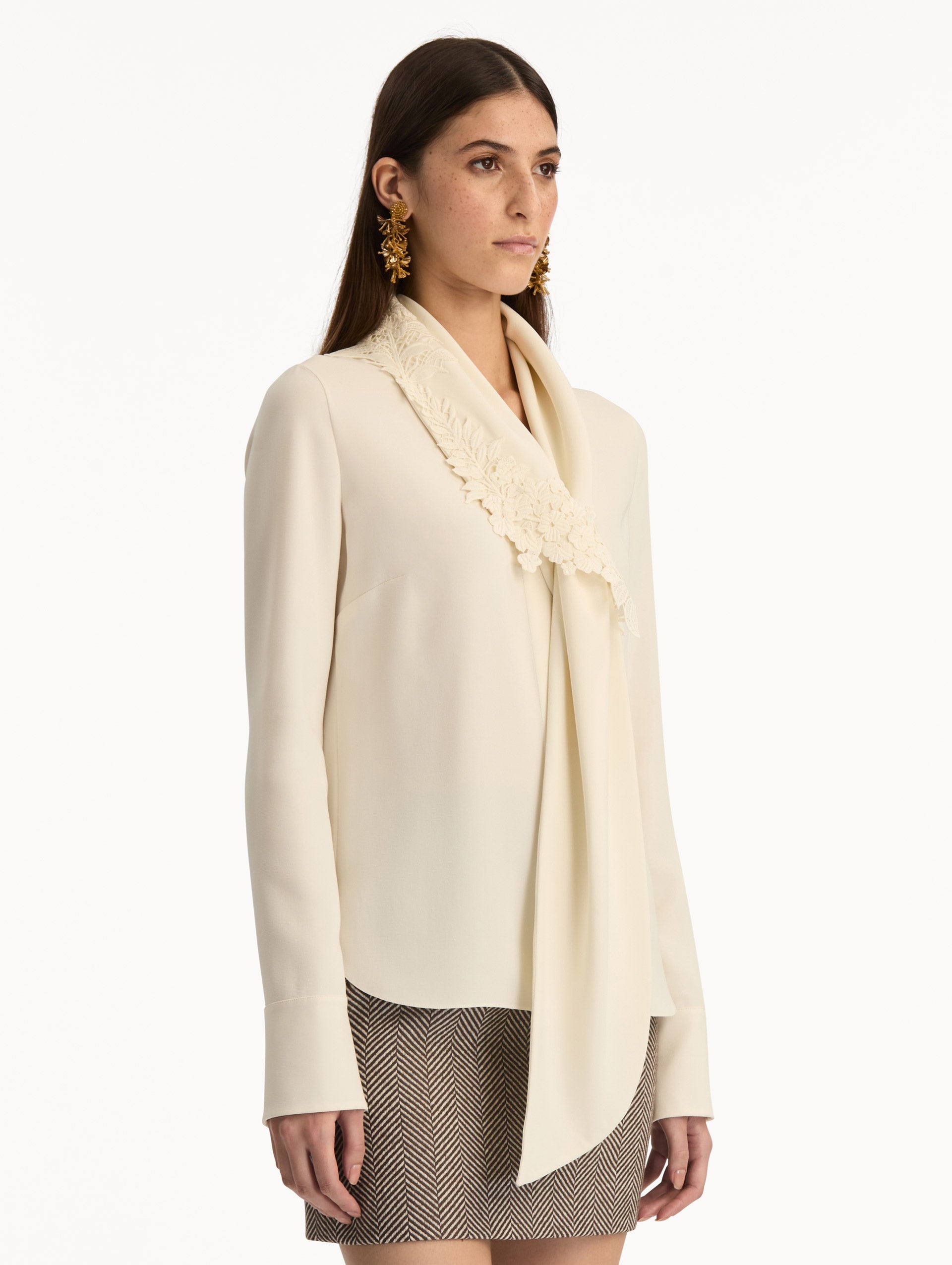 Ivory Foxglove Tie-Neck Georgette Blouse featuring a floral applique and long sleeves. Side View.