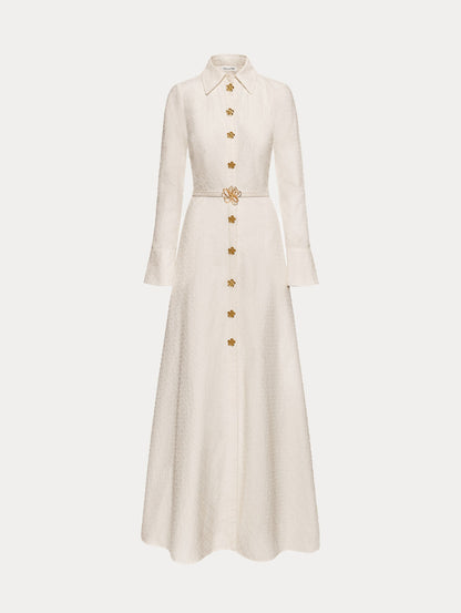 Ivory Oscar Chain-Link Cotton Poplin Caftan featuring a collared neckline, flared sleeves, gold button front, and belted waist with floral buckle.