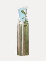 Dress in a light blue color with A-symmetric, one strap neckline, softly blurred floral design, and full fringe maxi length skirt.