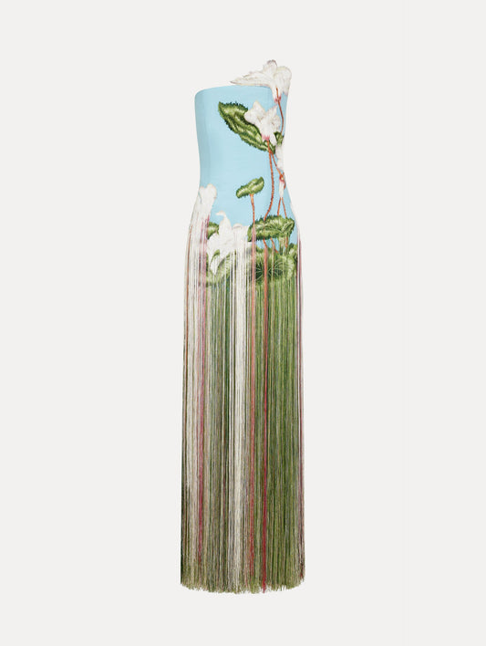 Dress in a light blue color with A-symmetric, one strap neckline, softly blurred floral design, and full fringe maxi length skirt.