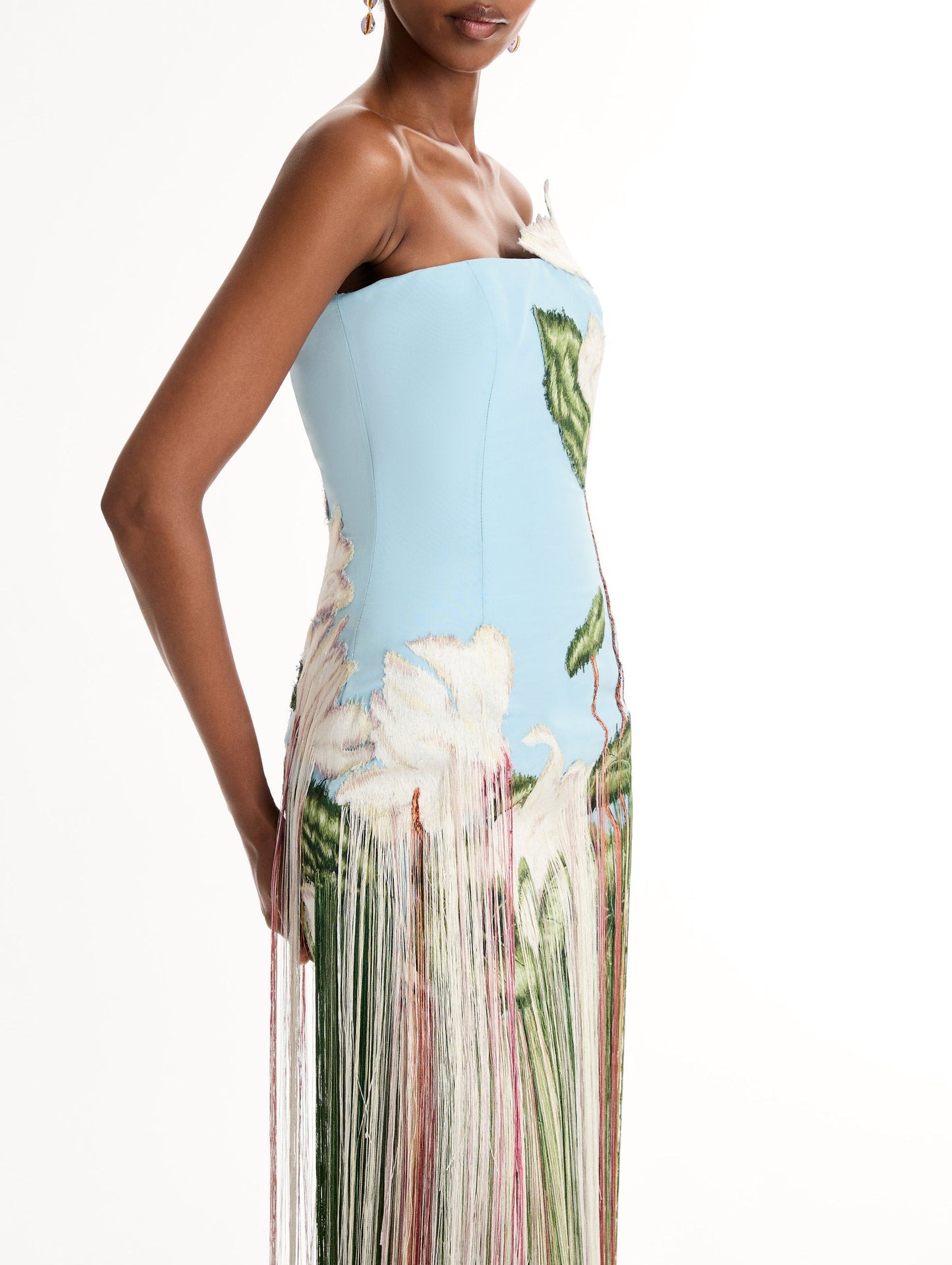 Strapless, Floor length silk faille gown with Chiné Cyclamen motif on threadwork fringe. Clean lines and a fitted bodice frame the embroidery. Close Up Side View.