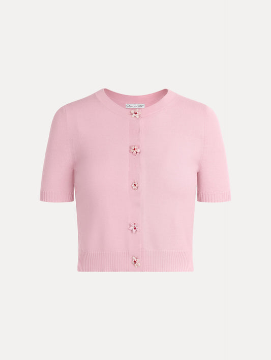 Knit short sleeve cardigan in the color light pink with ribbed hem and flower button front.