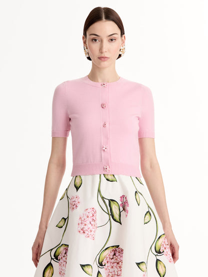 Light pink cropped cardigan, Floral Button closure, short sleeves. Front View