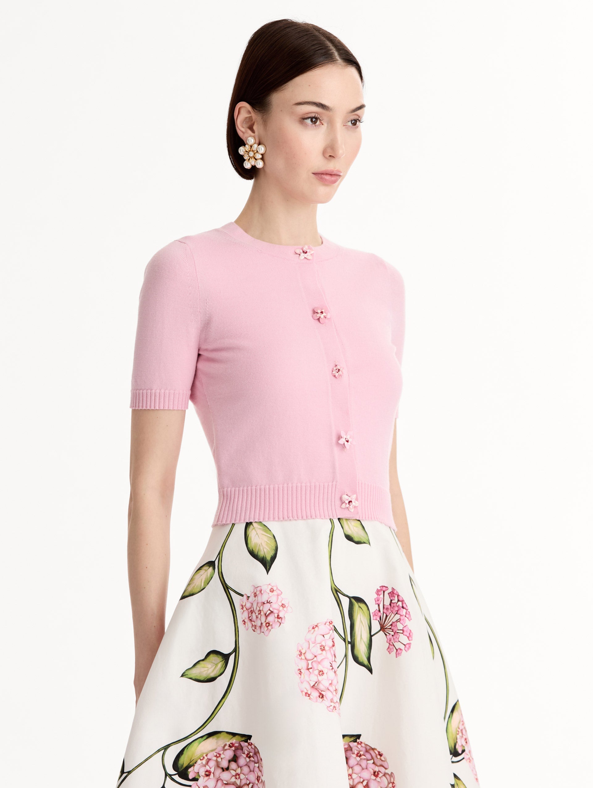 Light pink cropped cardigan, Floral Button closure, short sleeves. Side View