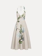 Dress in the colors White and Denim Blue with delicate halter V-neck, flowy skirt, and flower motif.
