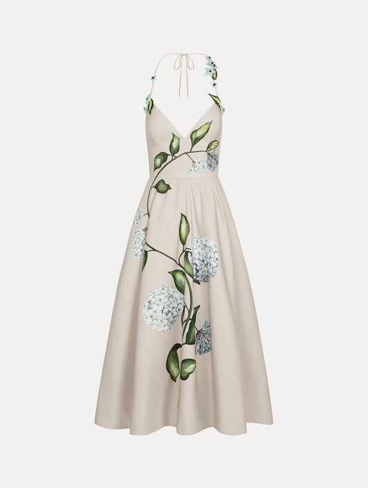 Dress in the colors White and Denim Blue with delicate halter V-neck, flowy skirt, and flower motif.