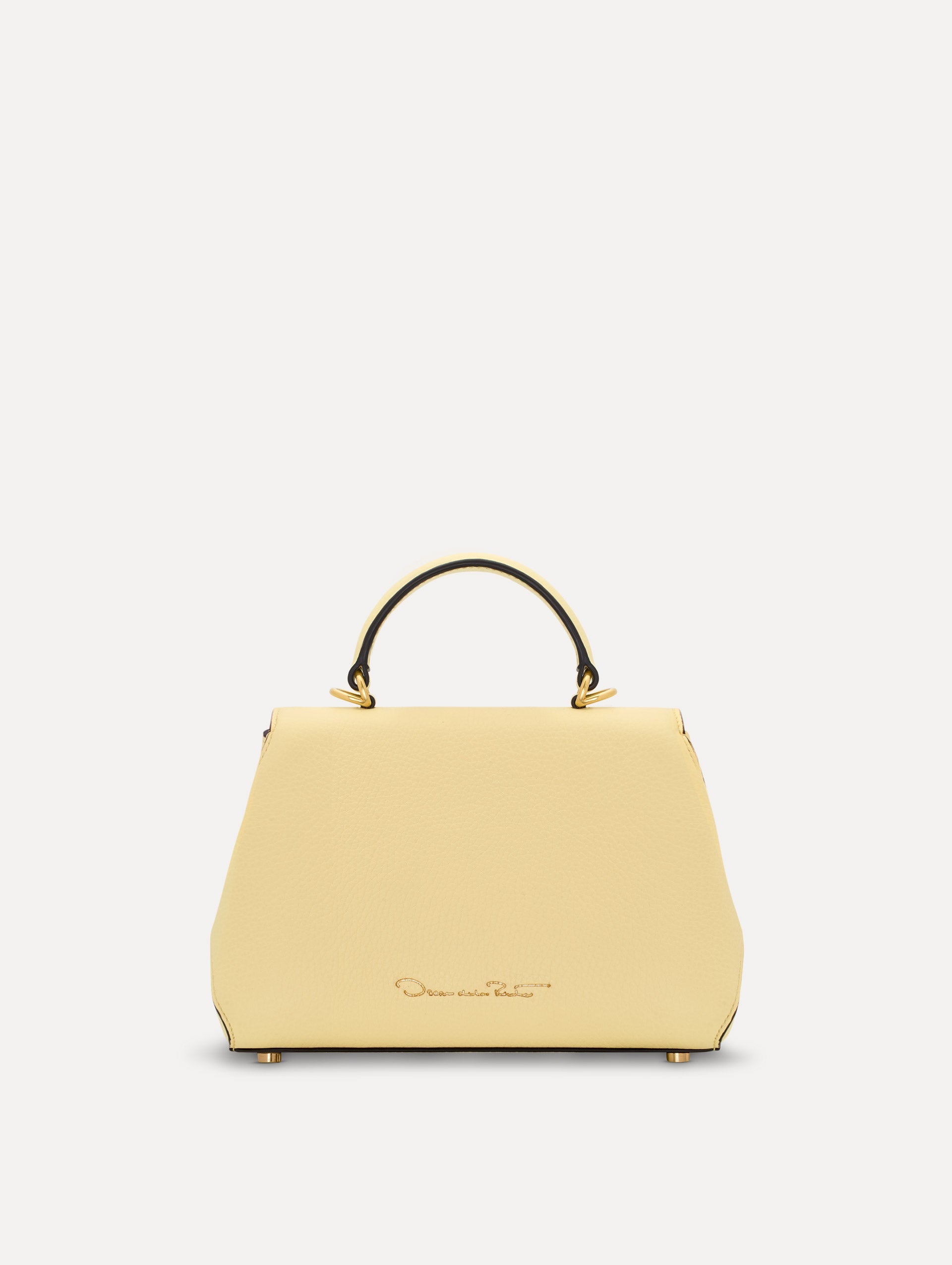 The Mini Poppy in yellow with floral cutout designs and gold hardware. Back View.