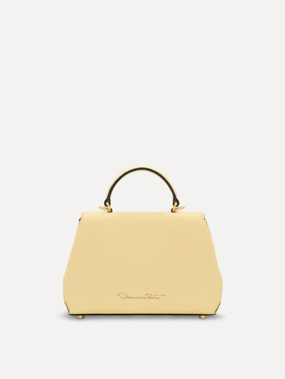 The Mini Poppy in yellow with floral cutout designs and gold hardware. Back View.