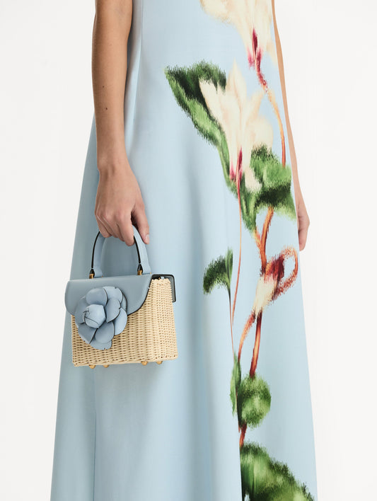 Blue Wicker Mini TRO Bag with a flower clasp and blue leather flap. Front View.
