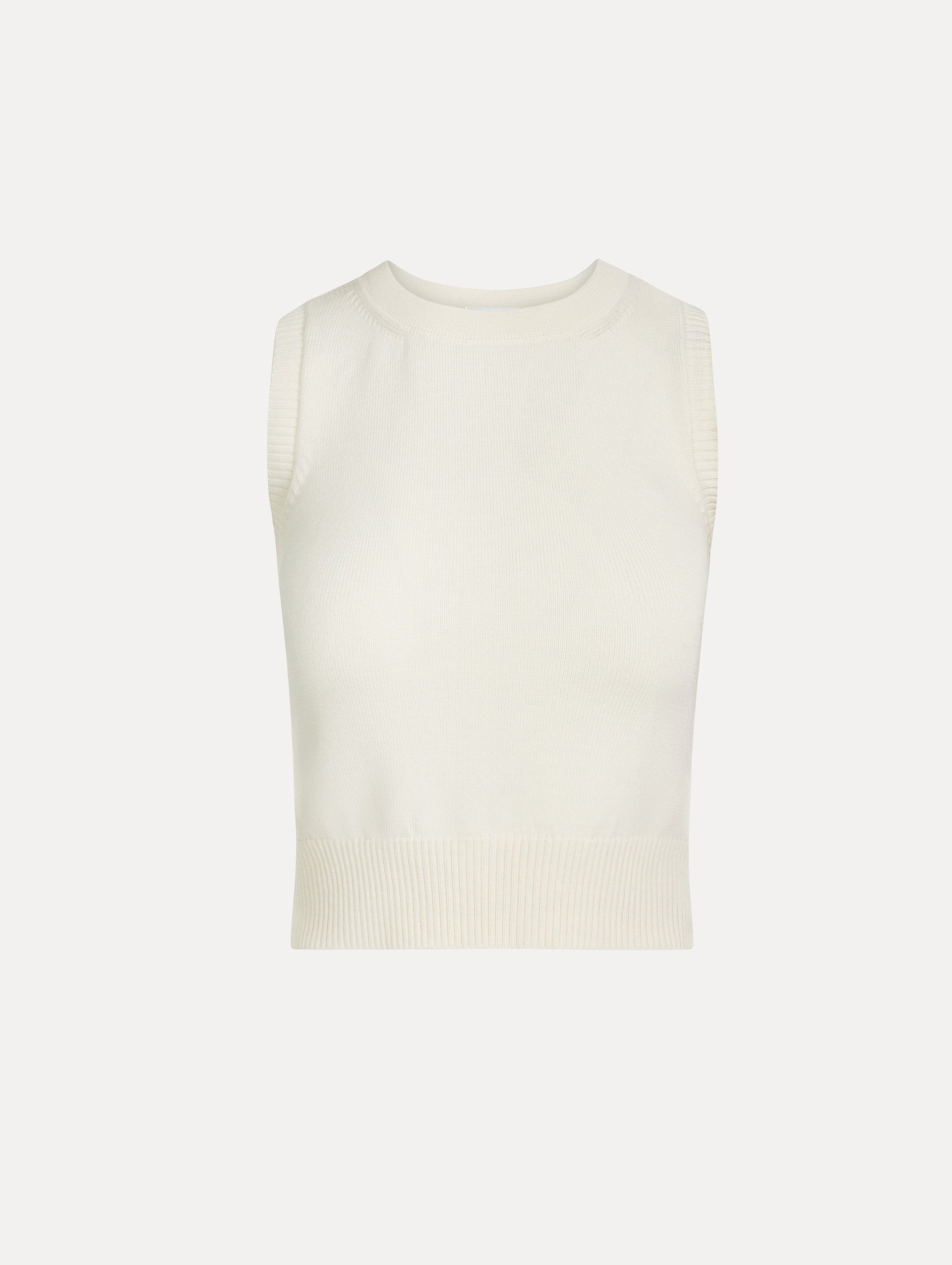Sleeveless, halter neck, classic knit tank in soft ivory. Front View.