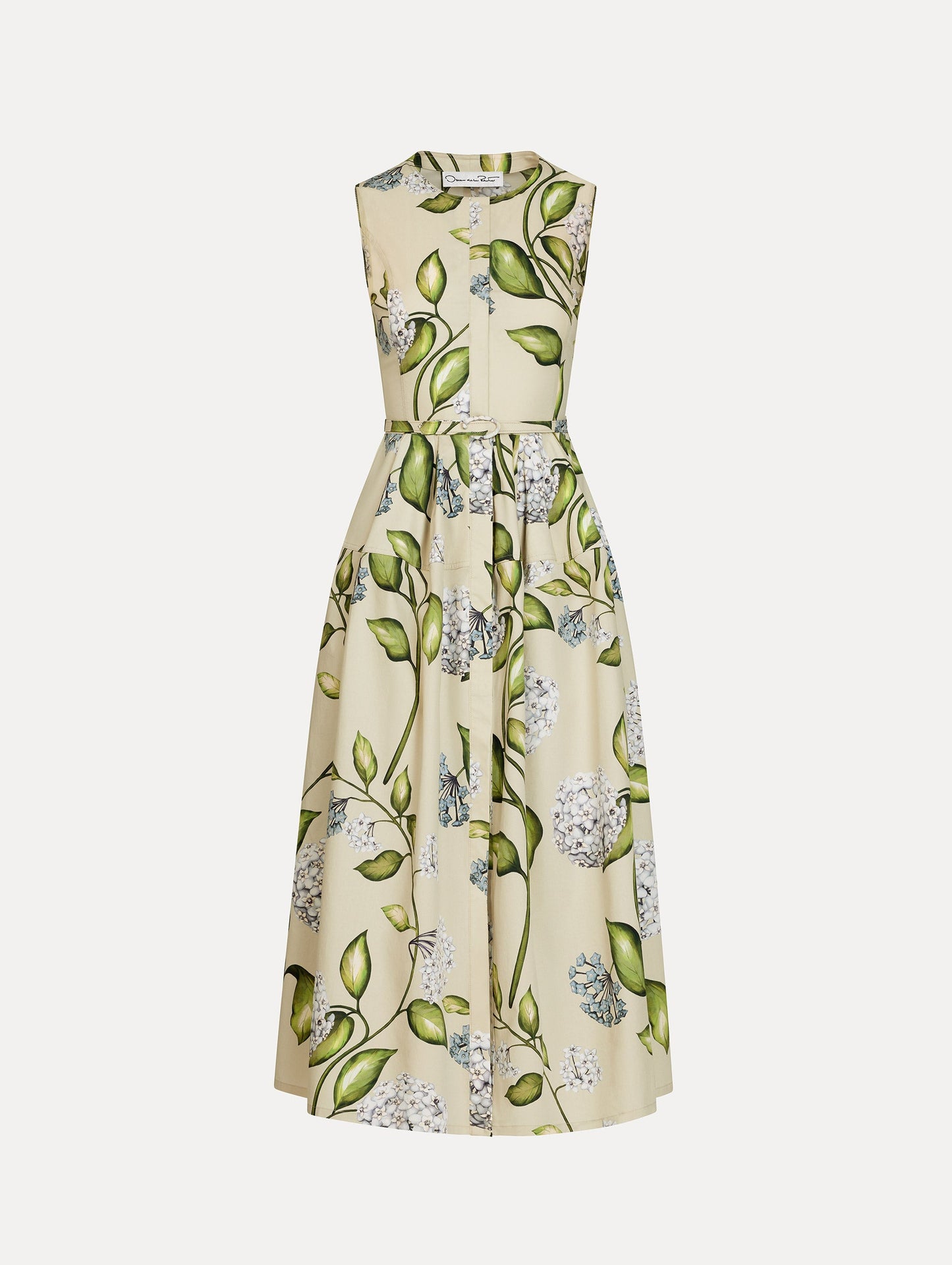 Porcelain Flower Cotton Poplin Dress in the colors Denim and Oatmeal featuring a printed floral motif and matching belt at the waist. Chiné Cyclamen Jersey Dress in the color Light Blue with asymmetric draped shoulder and softly blurred floral motif. Front View.
