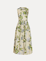 Porcelain Flower Cotton Poplin Dress in the colors Denim and Oatmeal featuring a printed floral motif and matching belt at the waist. Chiné Cyclamen Jersey Dress in the color Light Blue with asymmetric draped shoulder and softly blurred floral motif. Front View.