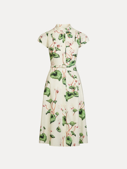 Chiné Cyclamen Cotton Poplin Cap Sleeve Dress in the colors White and Ivory, featuring a tailored bodice, flared midi skirt, short sleeves, concealed button front, matching belt at waist, and softly blurred floral print.