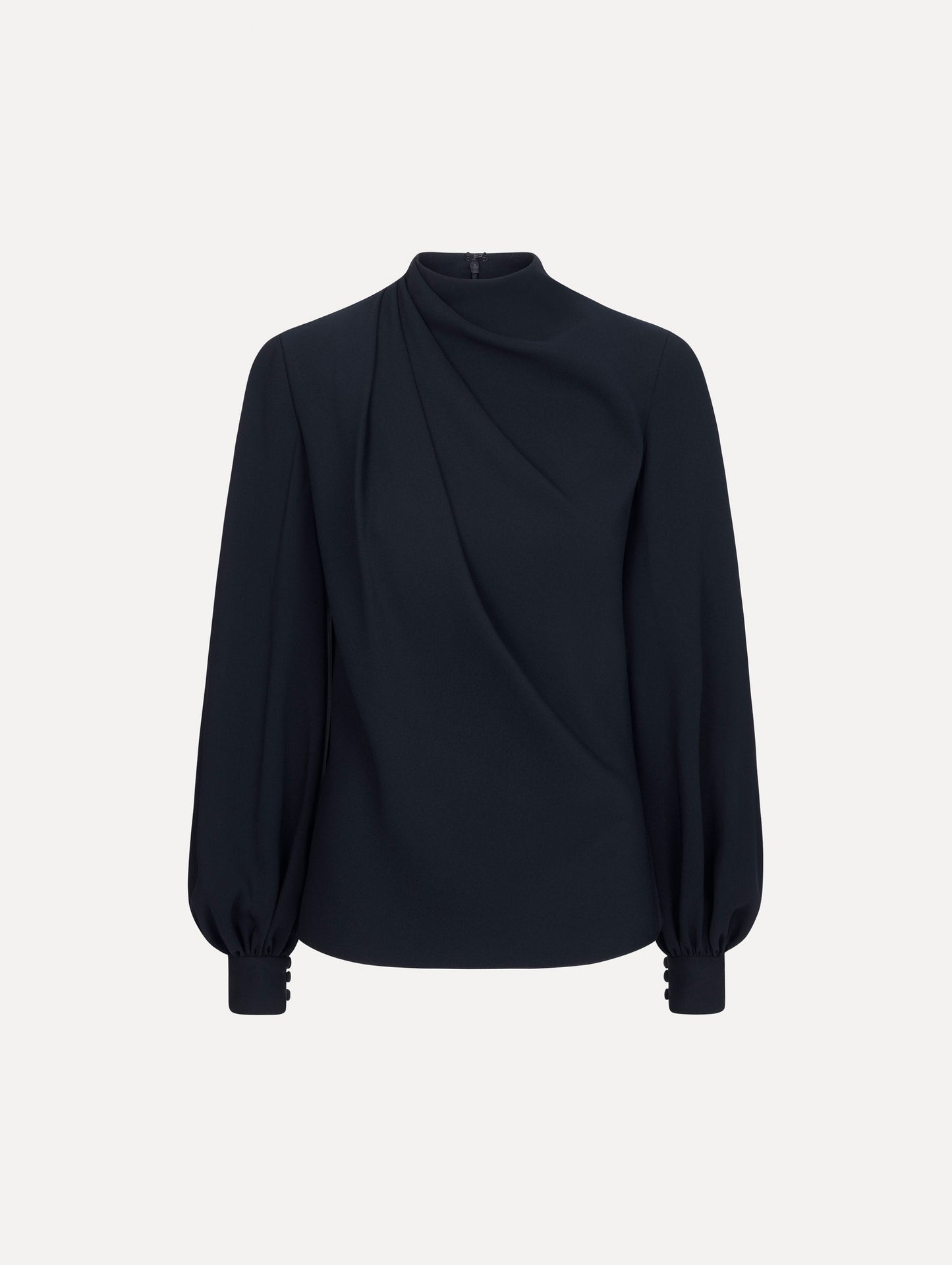 The model is wearing the Draped Georgette Blouse in the color Navy. Featuring silk georgette, a draping mock-neckline, and long, billowed sleeves. Front View.