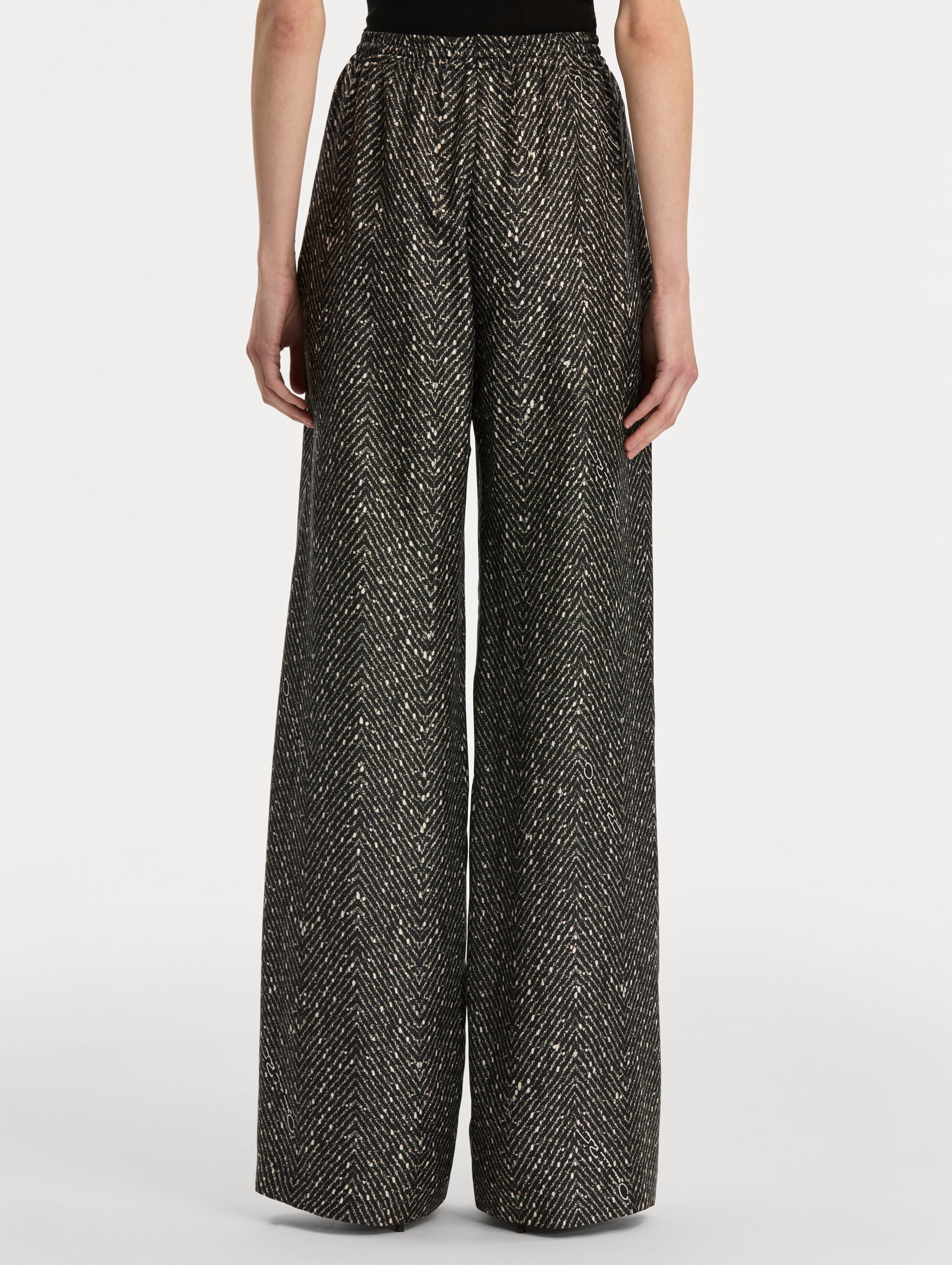 Black and Ivory Chevron Silk Twill Drawstring Pant featuring a high elastic waistband and fluid, shimmering drape. Back View.