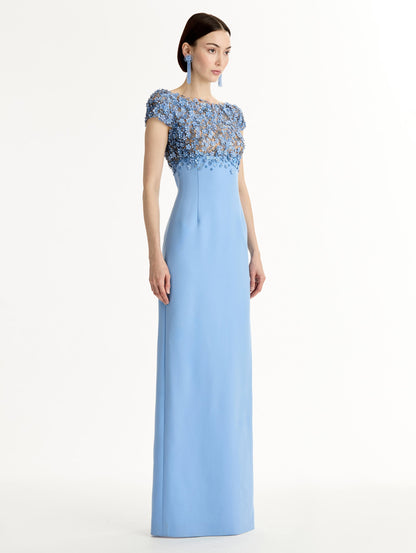 Blue floor length gown with Porcelain-flower motif on cap-sleeve bodice covered in sequins and crystals forming a delicate, petal-like lattice. Double-faced stretch wool skirt. Side View.