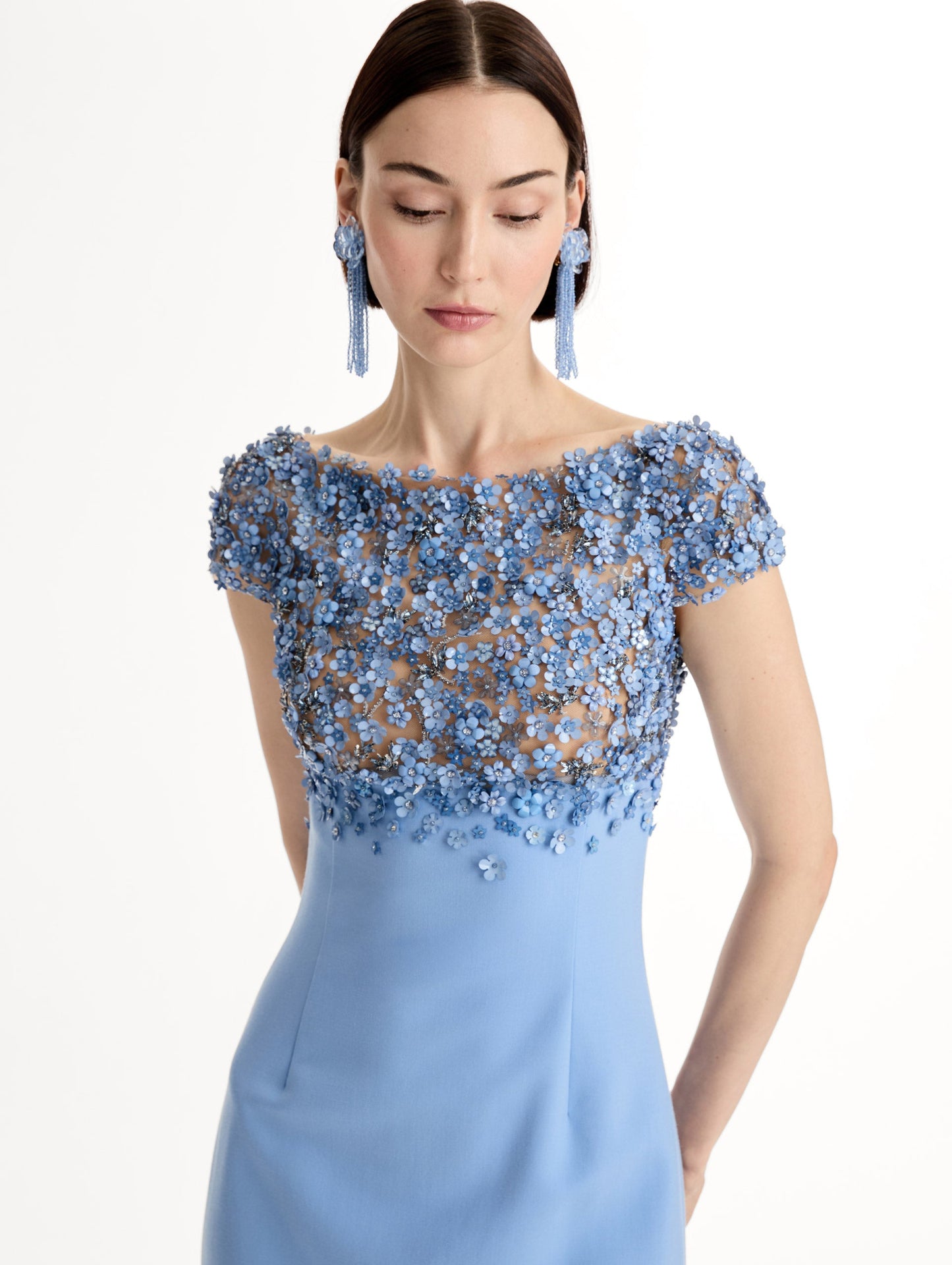 Blue floor length gown with Porcelain-flower motif on cap-sleeve bodice covered in sequins and crystals forming a delicate, petal-like lattice. Double-faced stretch wool skirt. Front View, Close Up.