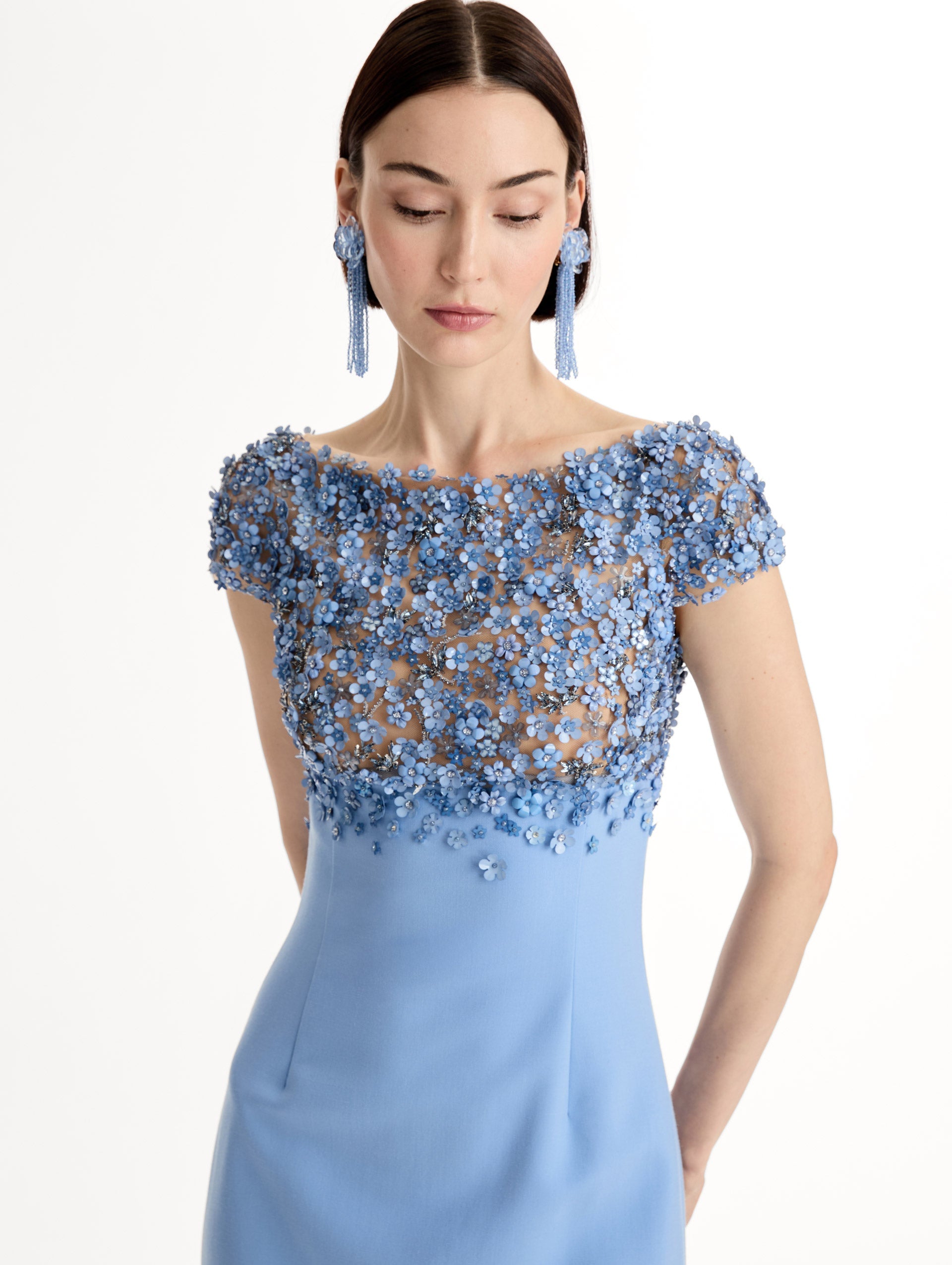 Blue floor length gown with Porcelain-flower motif on cap-sleeve bodice covered in sequins and crystals forming a delicate, petal-like lattice. Double-faced stretch wool skirt. Front View, Close Up.