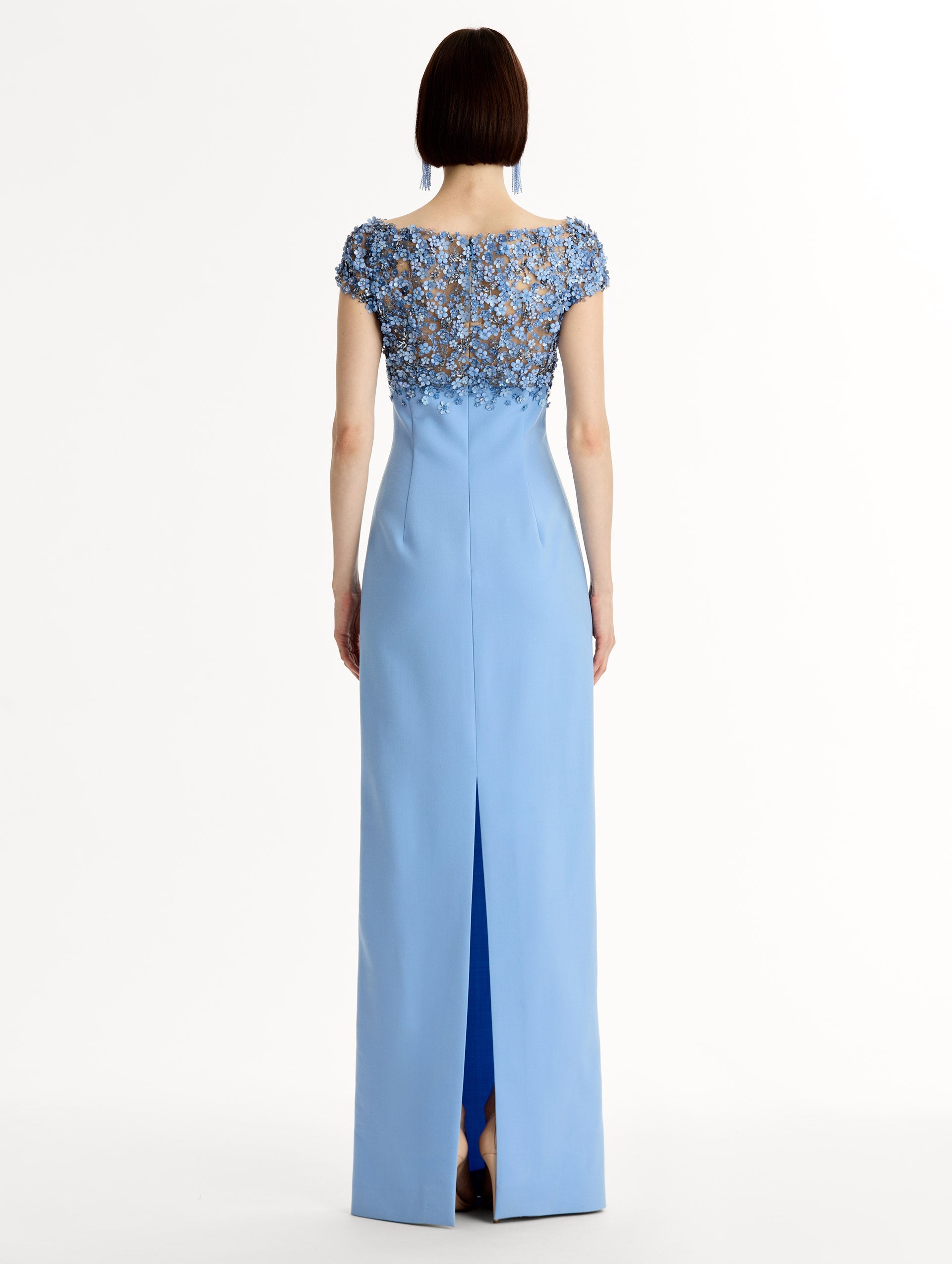 Blue floor length gown with Porcelain-flower motif on cap-sleeve bodice covered in sequins and crystals forming a delicate, petal-like lattice. Double-faced stretch wool skirt. Back View.