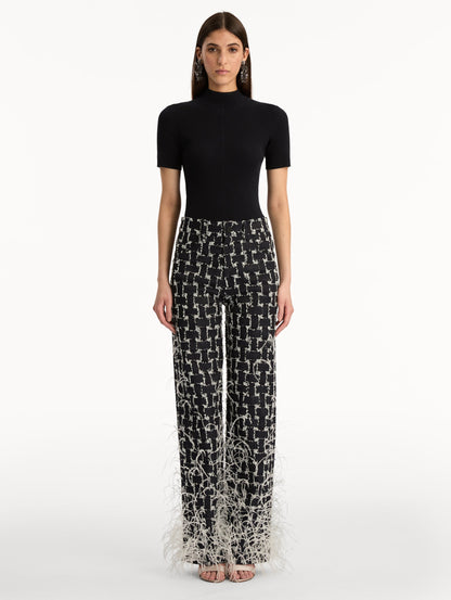 Black and White Woven Denim Jacquard Pant with feather detailing. Front View.