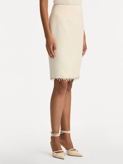 White Floral Jeweled Fringe Tweed Skirt featuring a fitted silhouette with jeweled applique along hem. Side View.